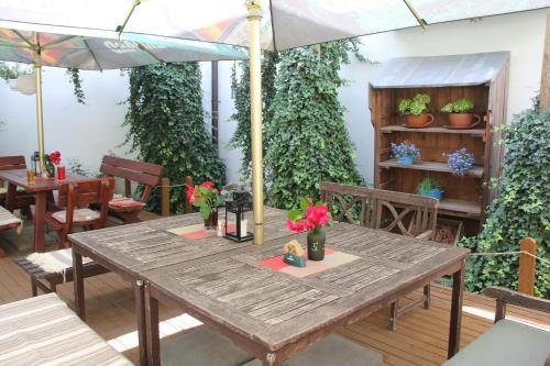 a wooden table with flowers on a patio at Penzion U Lucerny in Jindrichuv Hradec