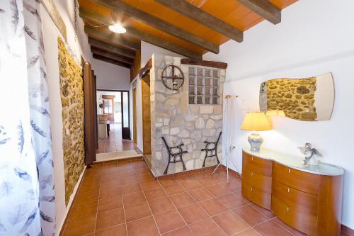 a hallway with a room with a stone wall at Marasolana in Jalón