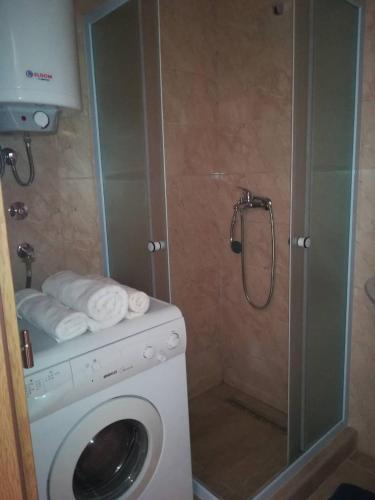 a washing machine in a bathroom with a shower at SWEET APT Zenica in Zenica
