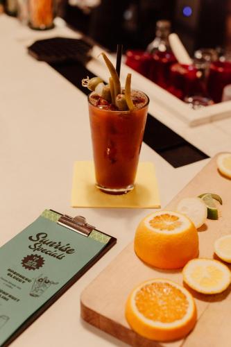 an orange cut in half next to a drink at The Quisby in New Orleans
