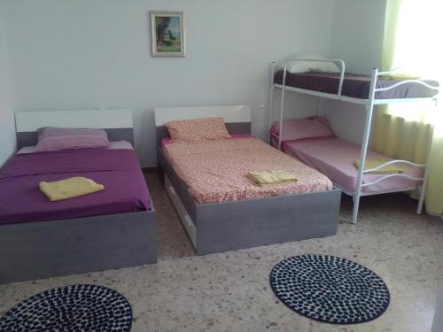 a bedroom with two beds and a bunk bed at NOEMI & JULIENNE in Spineda