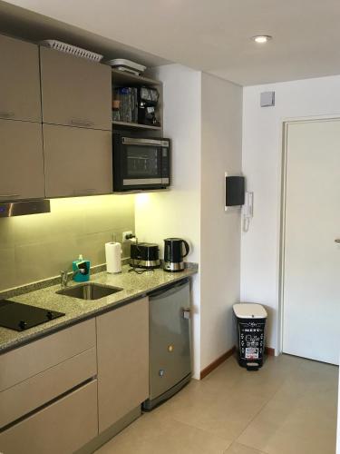 a kitchen with a sink and a counter top at 629 Serrano in Buenos Aires