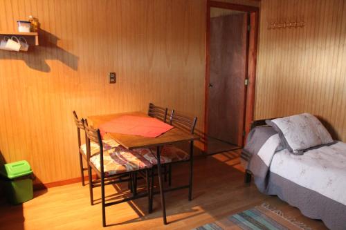 a dining room with a table and a bed at Don Zoilo in Castro