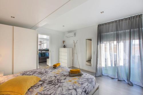 a bedroom with a large bed and a window at Maria Rita Faro Rooftop Apartment in Faro
