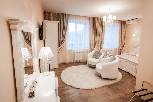 a bedroom with a bed and a living room at Hotel Ankor in Blagoveshchensk