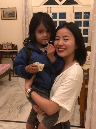 a woman and a child brushing their teeth at Jai Villa Homestay in Udaipur