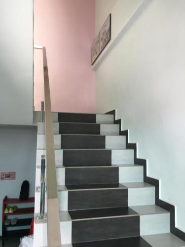 a staircase with black and white steps in a room at CK Homestay K.Sepetang in Taiping