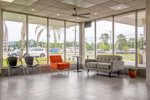 a lobby with chairs and a couch and a table at Motel 6-Starke, FL in Starke