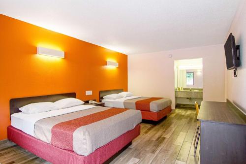 a hotel room with two beds and a television at Motel 6-Starke, FL in Starke