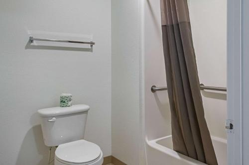 a bathroom with a toilet with a shower curtain at Motel 6-Bay Saint Louis, MS in Bay Saint Louis