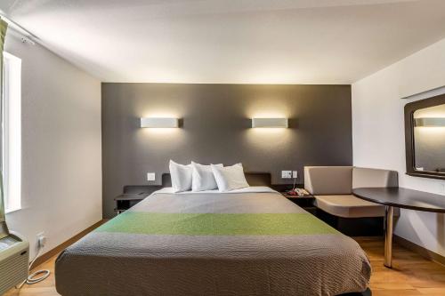 a hotel room with a bed and a table at Studio 6-San Marcos, TX in San Marcos