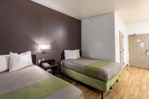 a small room with two beds in a room at Studio 6-Mcallen, TX in McAllen