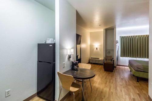a small room with a table and a refrigerator at Studio 6-Mcallen, TX in McAllen