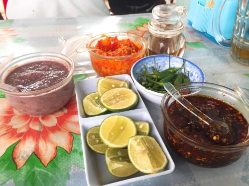 a table topped with a plate of food and dip at Bảo Lộc Homestay in Bao Loc