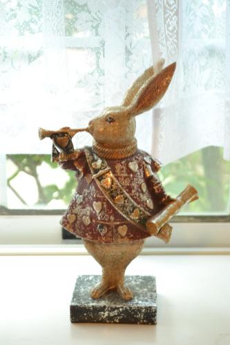 a figurine of a rabbit on a stand in front of a window at AMAMI-Green-Garden in Amami