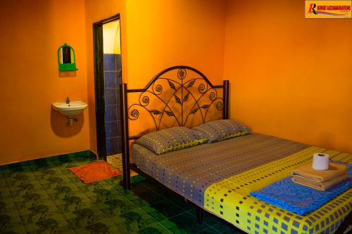 a bedroom with a bed and a lamp at RL Budget Rooms in Pantai Cenang