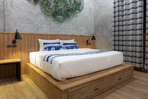 a bedroom with a large bed with blue pillows at The Chic Lipe in Ko Lipe
