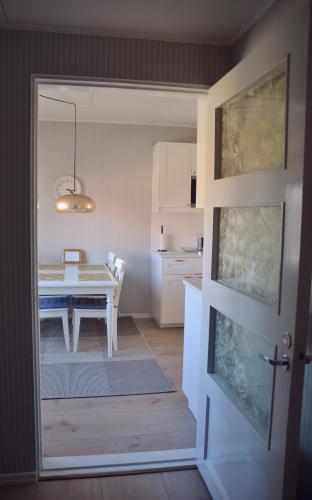 a kitchen with a table and a dining room at Putiikkihotelli Kemi 1932 in Kemi