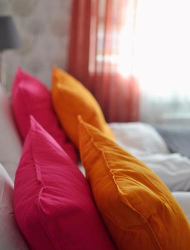 a group of pillows on a couch at Putiikkihotelli Kemi 1932 in Kemi