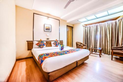a bedroom with a large bed in a room at Hotel Gandharva Shivajinagar in Pune