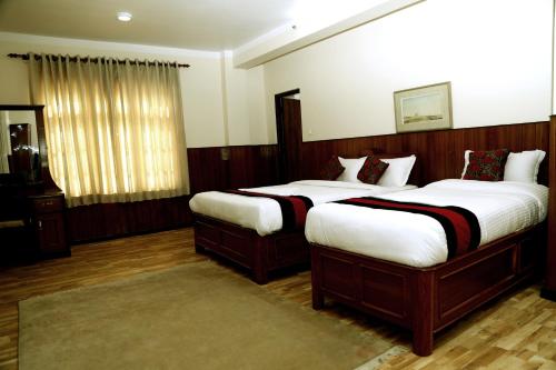 two beds in a hotel room with at Green Eco Resort in Kirtipur