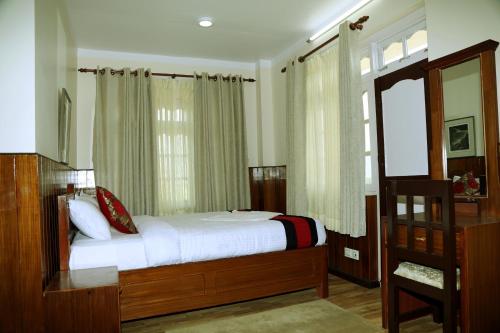 a bedroom with a bed and a window at Green Eco Resort in Kirtipur