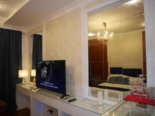 a television sitting on a counter in a room at Trillium Residences Ayala Cebu in Cebu City
