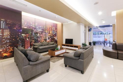 a large living room with couches and a tv at Hotel 88 Mangga Besar 62 - Best Breakfast - Near By Ancol And Government Center in Jakarta