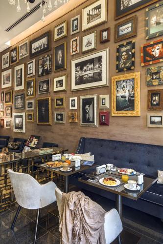 a restaurant with two tables and pictures on the wall at The Venice Times in Venice