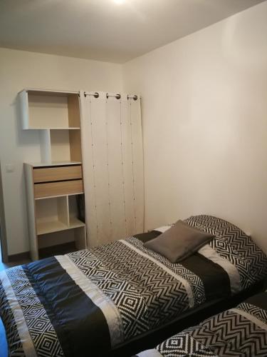 - une petite chambre avec un lit et un placard dans l'établissement beau T2 lumineux 1er etage, à Rochefort