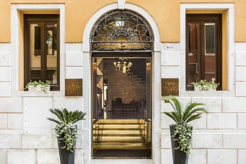 an entrance to a building with a gold staircase at Venice Times Hotel in Venice