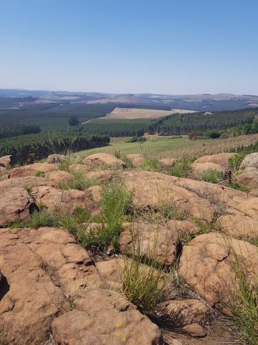 a view from the top of a mountain with rocks at Forest Hill Country Lodge in Piet Retief