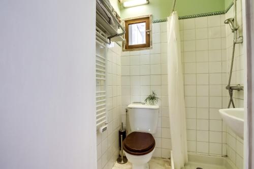 a bathroom with a toilet and a sink at Apartment Tour Eiffel by Weekome in Paris