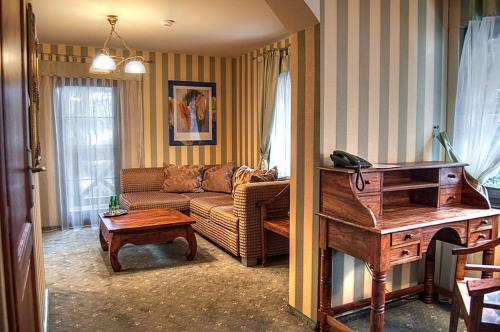 a living room with a couch and a piano at Willa Silesia in Wisła