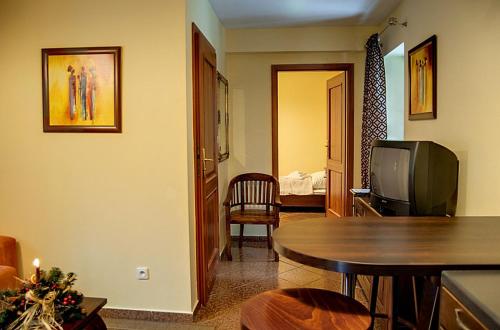 a living room with a table and a television at Willa Silesia in Wisła