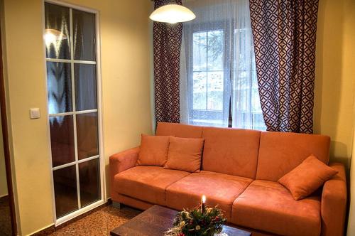 a living room with a couch and a window at Willa Silesia in Wisła