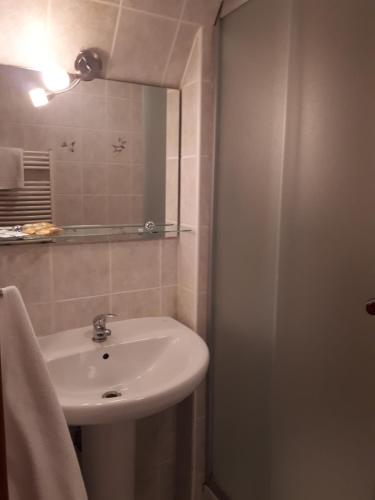 a bathroom with a sink and a mirror at Willa Silesia in Wisła