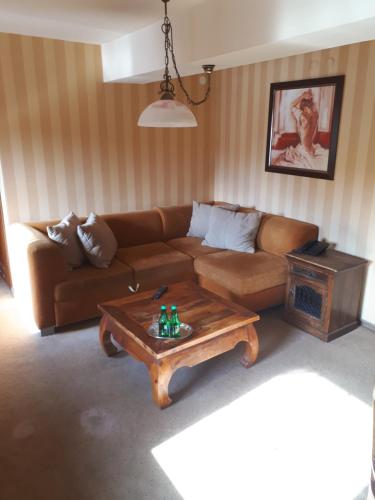 a living room with a couch and a coffee table at Willa Silesia in Wisła