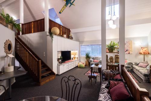 a living room with a couch and a tv at Land Of Lost Treasure in Maleny