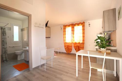 a kitchen and dining room with a table and chairs at Villaggio Olm&egrave; in Cessalto