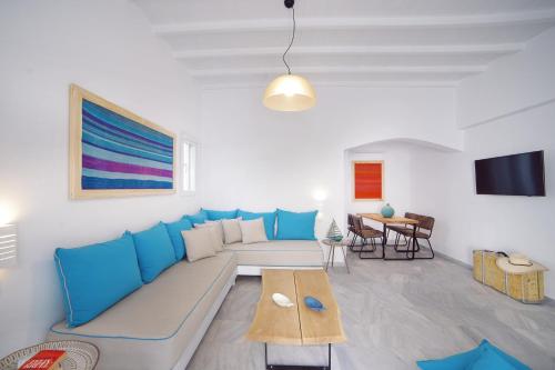 a living room with a blue couch and a table at Mykonos Town Suites in Mikonos
