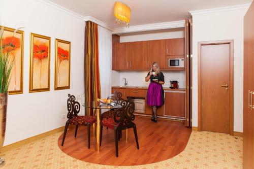 a woman is standing in a kitchen at Thermalhotel Gass in Bad Füssing