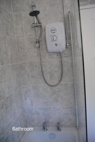 a shower in a bathroom with a sink at Ash House in Uppingham