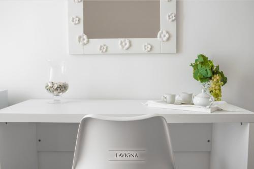 a white desk with two chairs and a mirror at Tenuta Vigna del Noce in Corato
