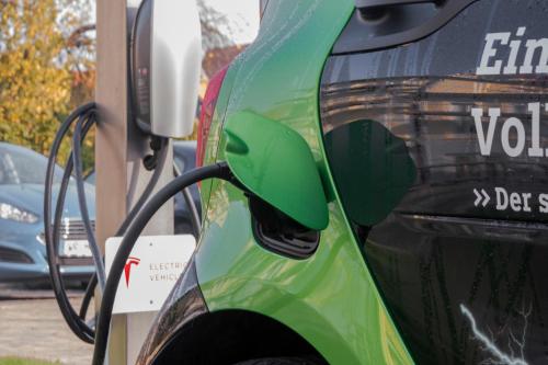 a green car is being charged at a gas station at Boutiquehotel Schloßpalais in Wernigerode