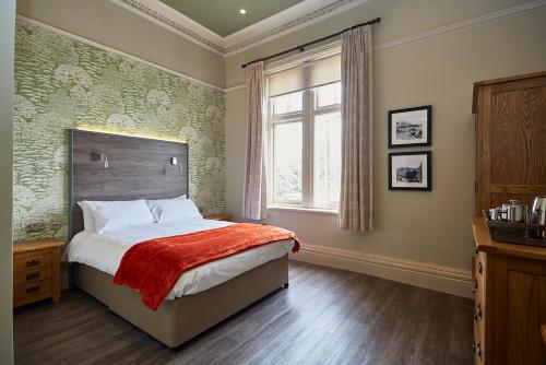 a bedroom with a bed and a window in it at Gwesty Links in Llandudno