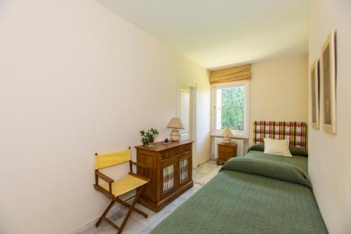 a bedroom with two green beds and a window at Villa Duque Los Monteros Marbella in Marbella