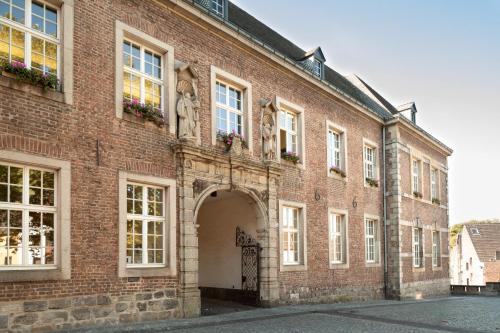 a large red brick building with a large doorway at H4 Hotel Mönchengladbach im BORUSSIA-PARK in Mönchengladbach
