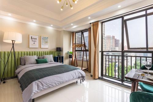 a bedroom with a bed and a large window at Wuhan Hongshan·Guanggu Square· Locals Apartment 00157650 in Wuhan