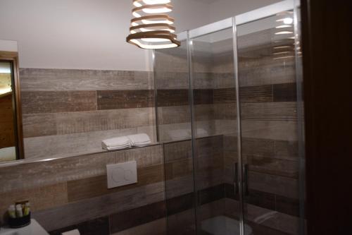 a bathroom with a shower with a glass door at Hotel Filey in Antey-Saint-André